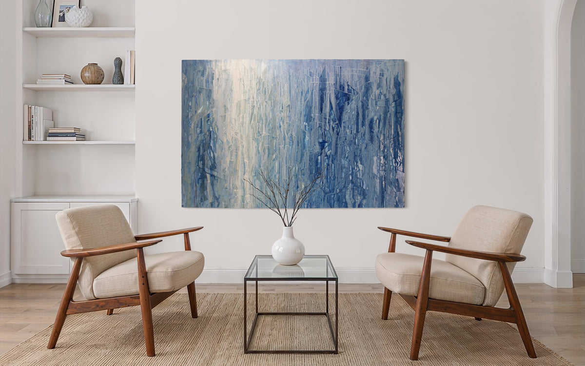 Modern living room with two armchairs and a coffee table, featuring an original abstract blue painting by Teo Guererra on the wall.