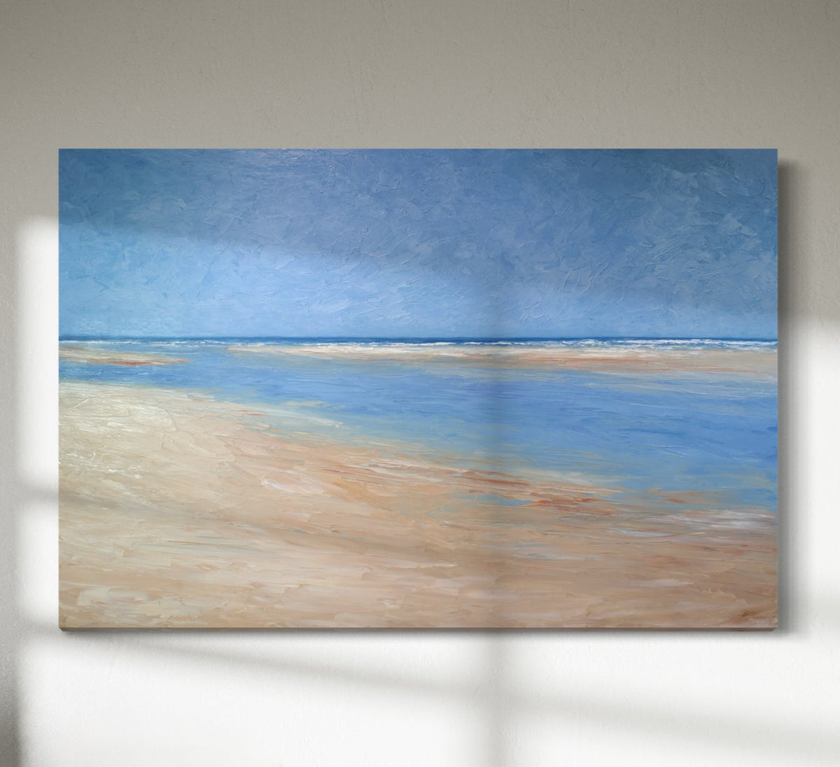 An abstract seascape painting hangs on a white wall. 