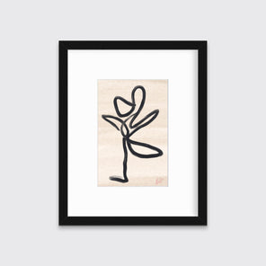 A black and beige abstract print by Hazal Ozturk framed in a black frame hangs on a light grey wall. 