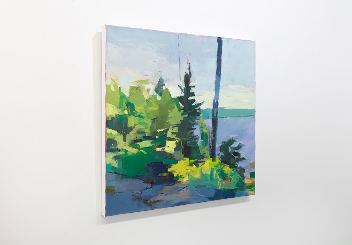 An abstract landscape painting hangs on a white wall.