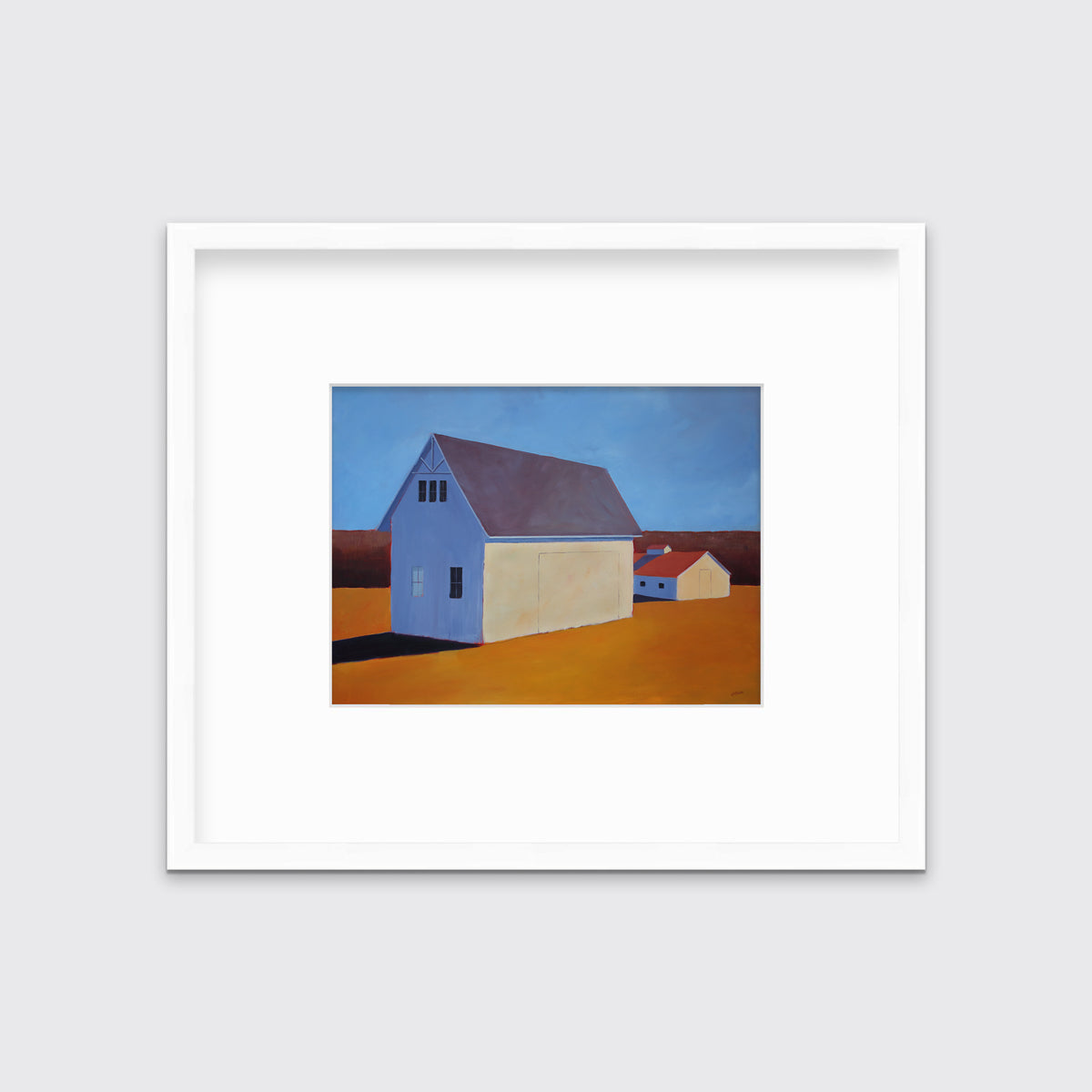 A blue and orange contemporary barn print in a white frame with a mat hangs on a white wall.