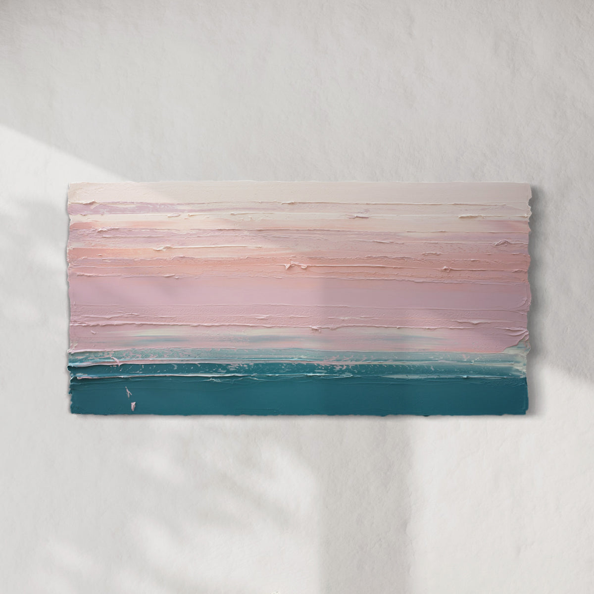 A peach, orange, coral, pale pink and teal thickly textured abstract painting hangs on a white wall with sunlight cascading over it.