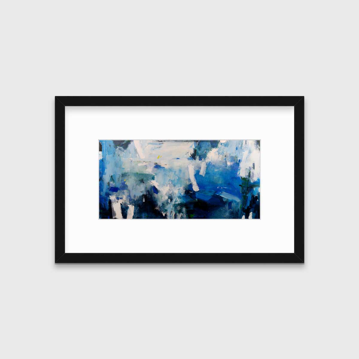 A blue and white abstract print in a black frame with a mat hangs on a white wall.
