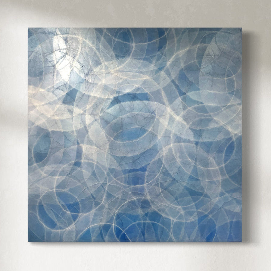 An original abstract painting featuring circular patterns in blue tones on a square canvas.