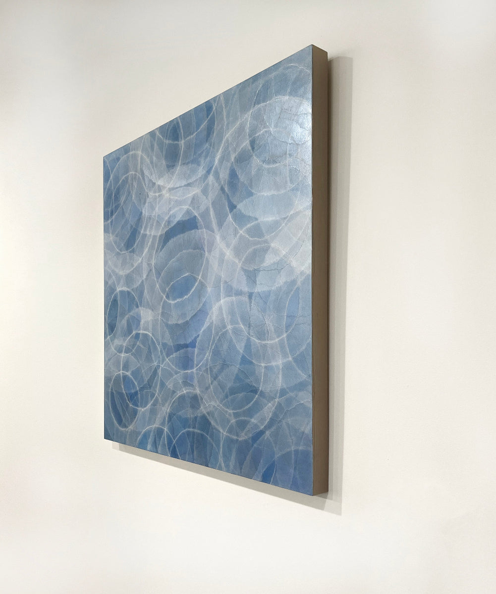 Abstract blue and white artwork on a white wall