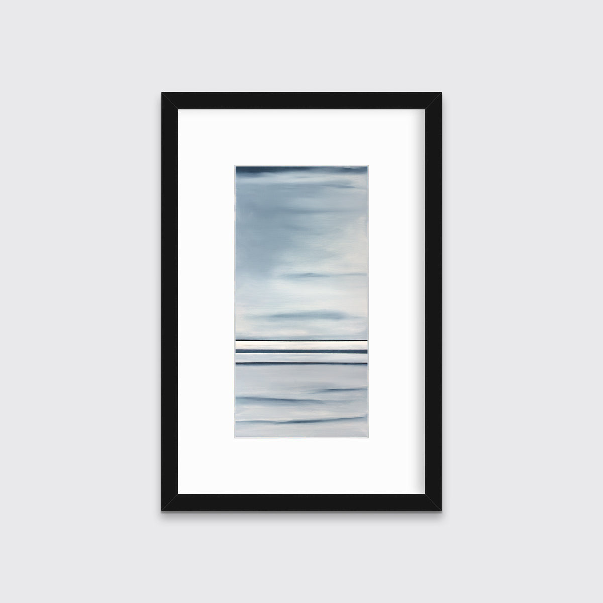 Blue and white abstract print in a black frame with a mat hangs on a white wall.