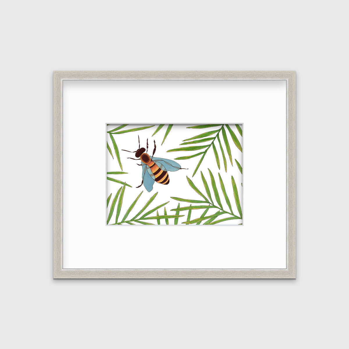 A white and green bee illustration print in a silver frame with a mat hangs on a white wall.