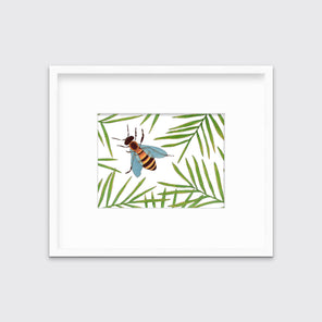 A white and green bee illustration print in a white frame with a mat hangs on a white wall. 