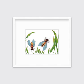 A minimalist bee illustration print in a white frame with a mat hangs on a white wall.