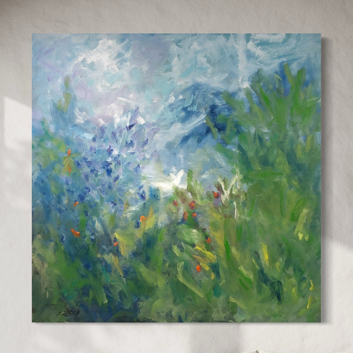 Colorful abstract floral painting with green, blue, and red hues on a gray background