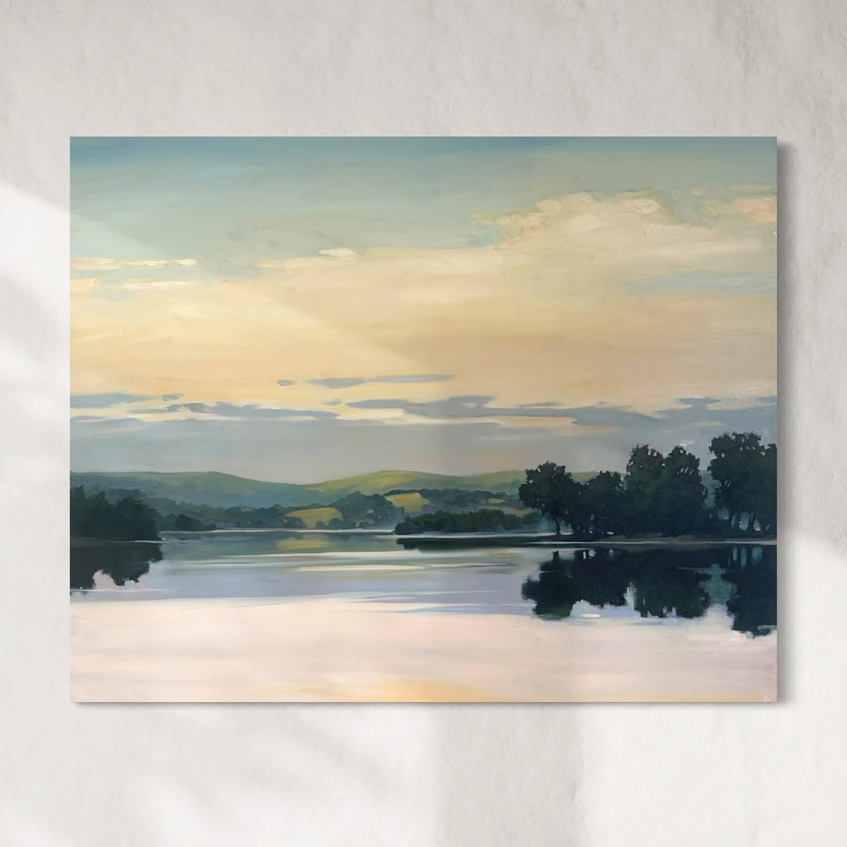 Painting of a landscape with a lake, trees, and a sunset sky.