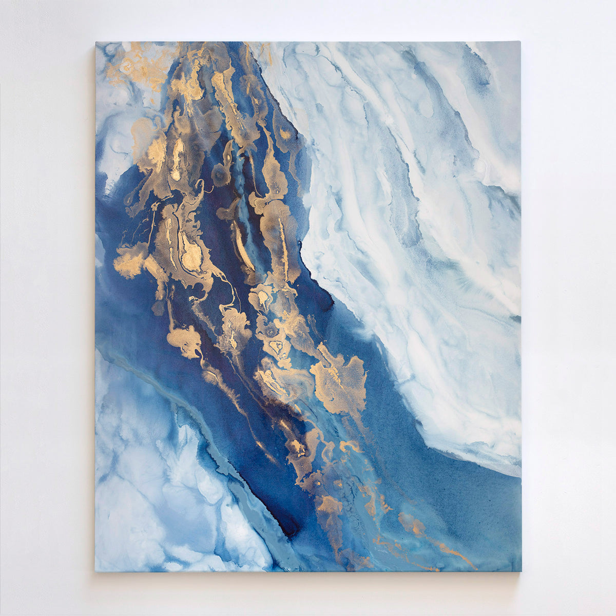 Abstract art painting with blue and gold tones on a white wall
