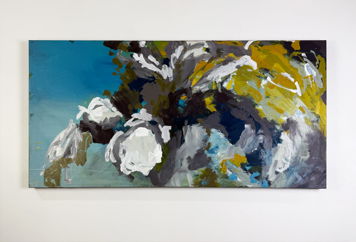 Abstract painting with a mix of colors on a white wall