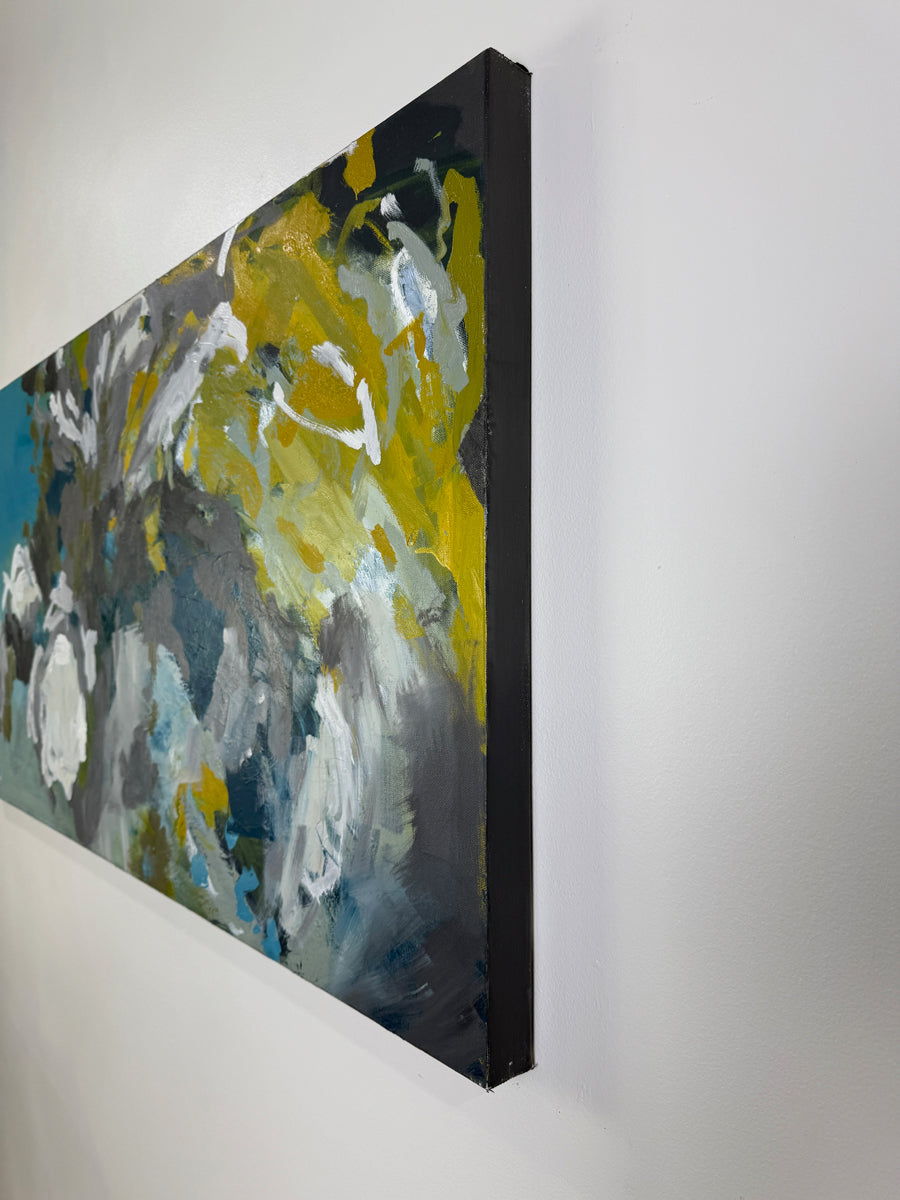 Abstract painting with yellow, gray, and blue on a white wall