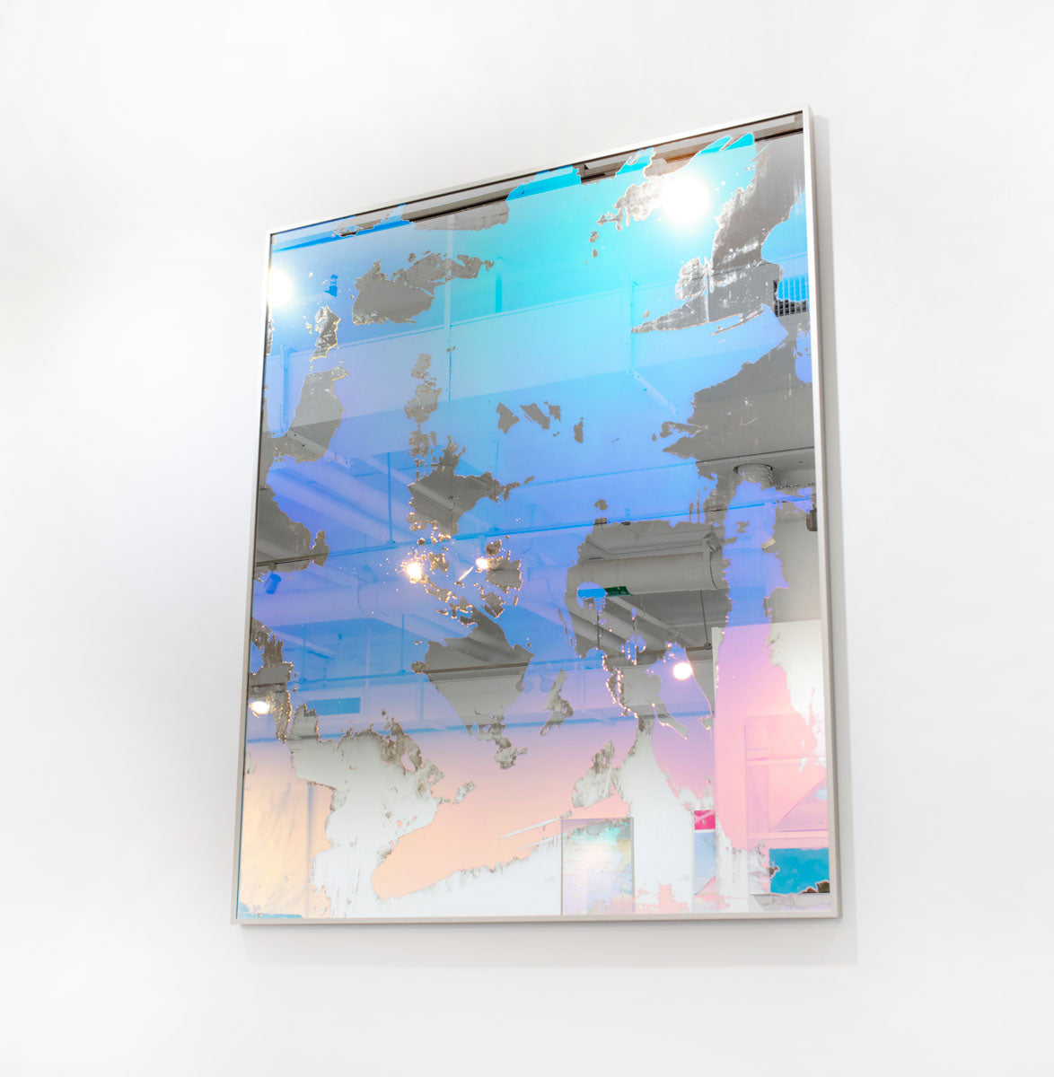 A blue and pink fine art mirror on a white wall. 