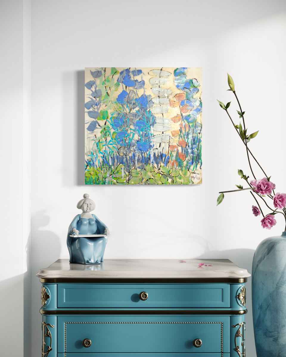A green and blue abstracted encaustic painting hangs on a white wall above a deep blue dresser with gold embellishments. A blue statue figurine rests on the surface of the dresser, with a large blue vase to the right. 