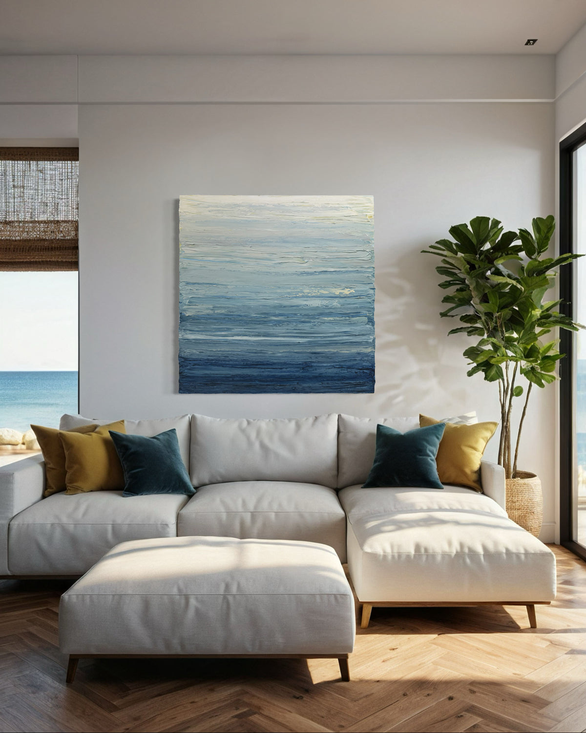 A blue, beige, lavender and light yellow textured abstract painting by Teodora Guererra hangs on a wall over a sofa in a beach house.