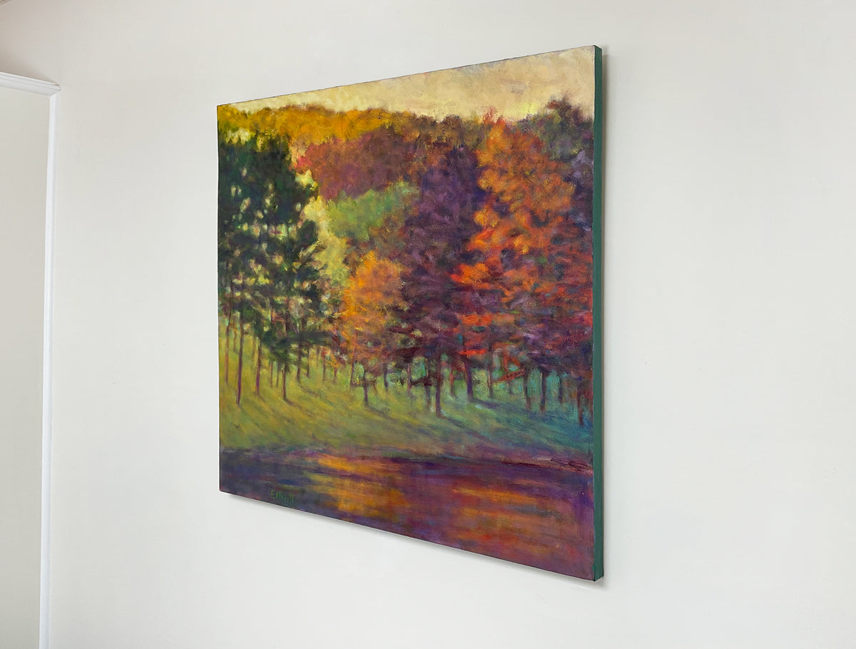 Painting of a forest scene with autumn colors on a white wall.