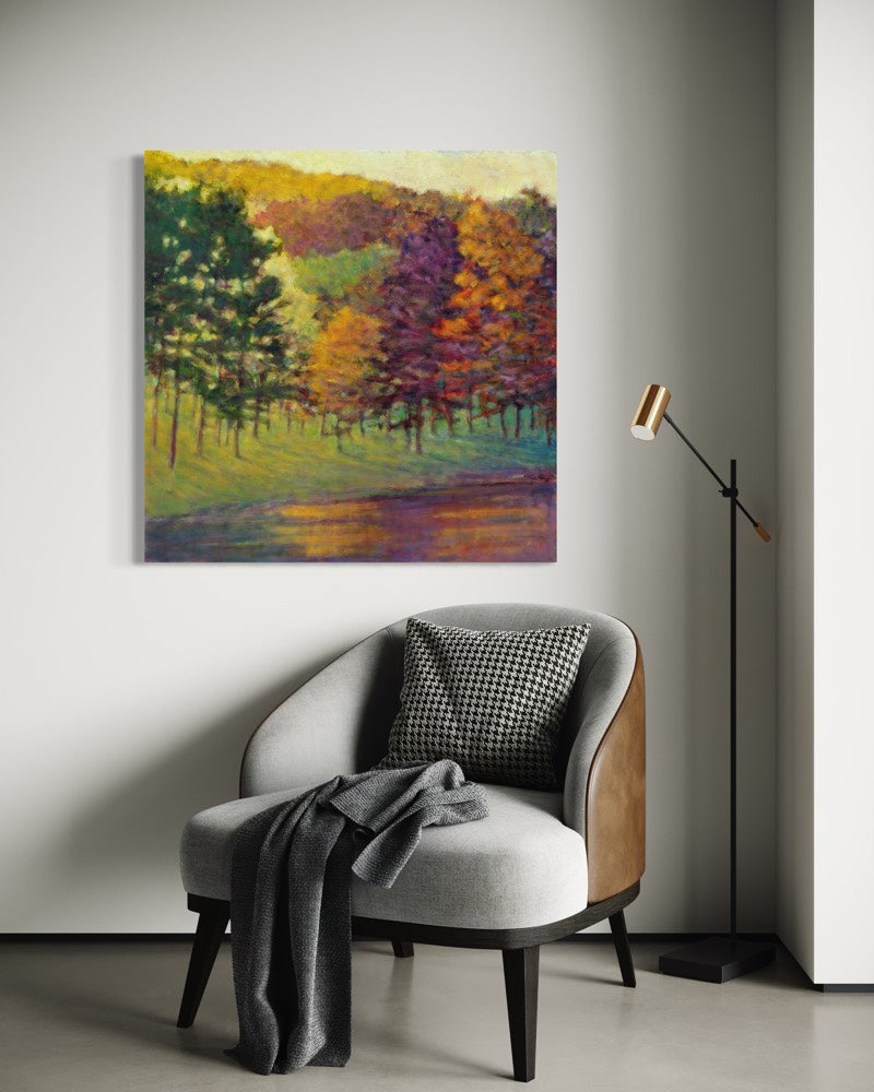 Colorful forest painting on a wall above a modern chair with a lamp.