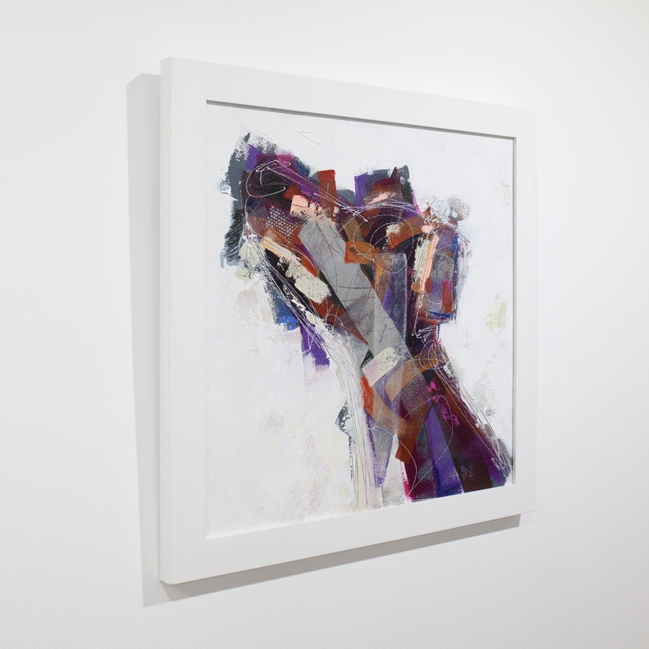 An abstracted painting of a dog framed in a white frame hangs on a white wall.