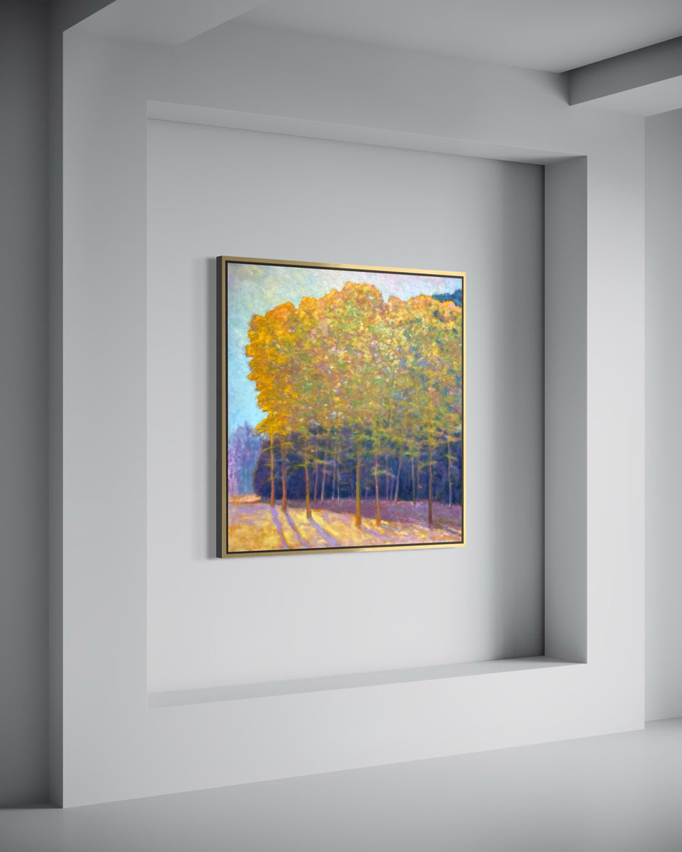 Framed painting of trees on a wall in a minimalistic room