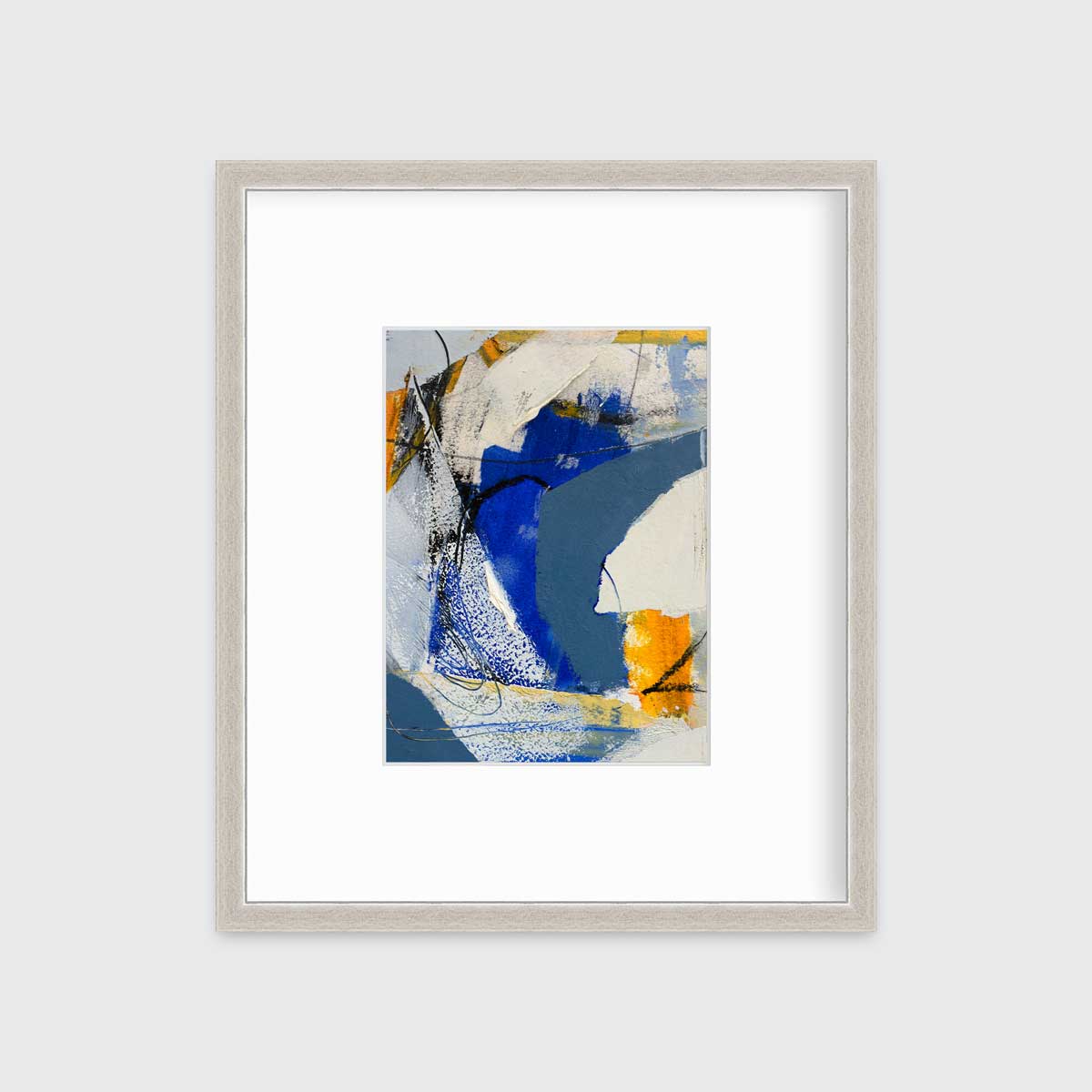A blue, grey and yellow abstract print in a silver frame with a mat hangs on a white wall.