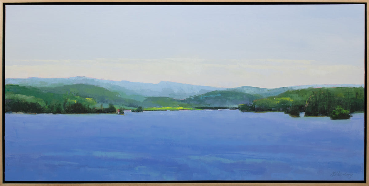 A blue and green landscape painting framed in a light wood frame.