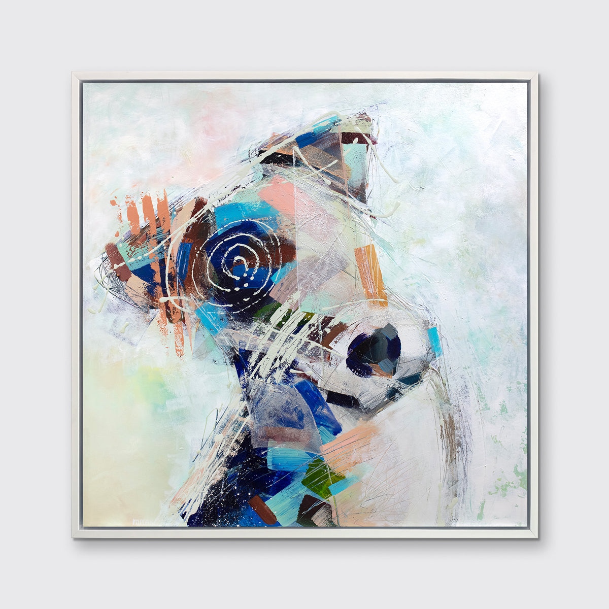 A multicolored abstract dog print in a white floater frame hangs on a white wall.