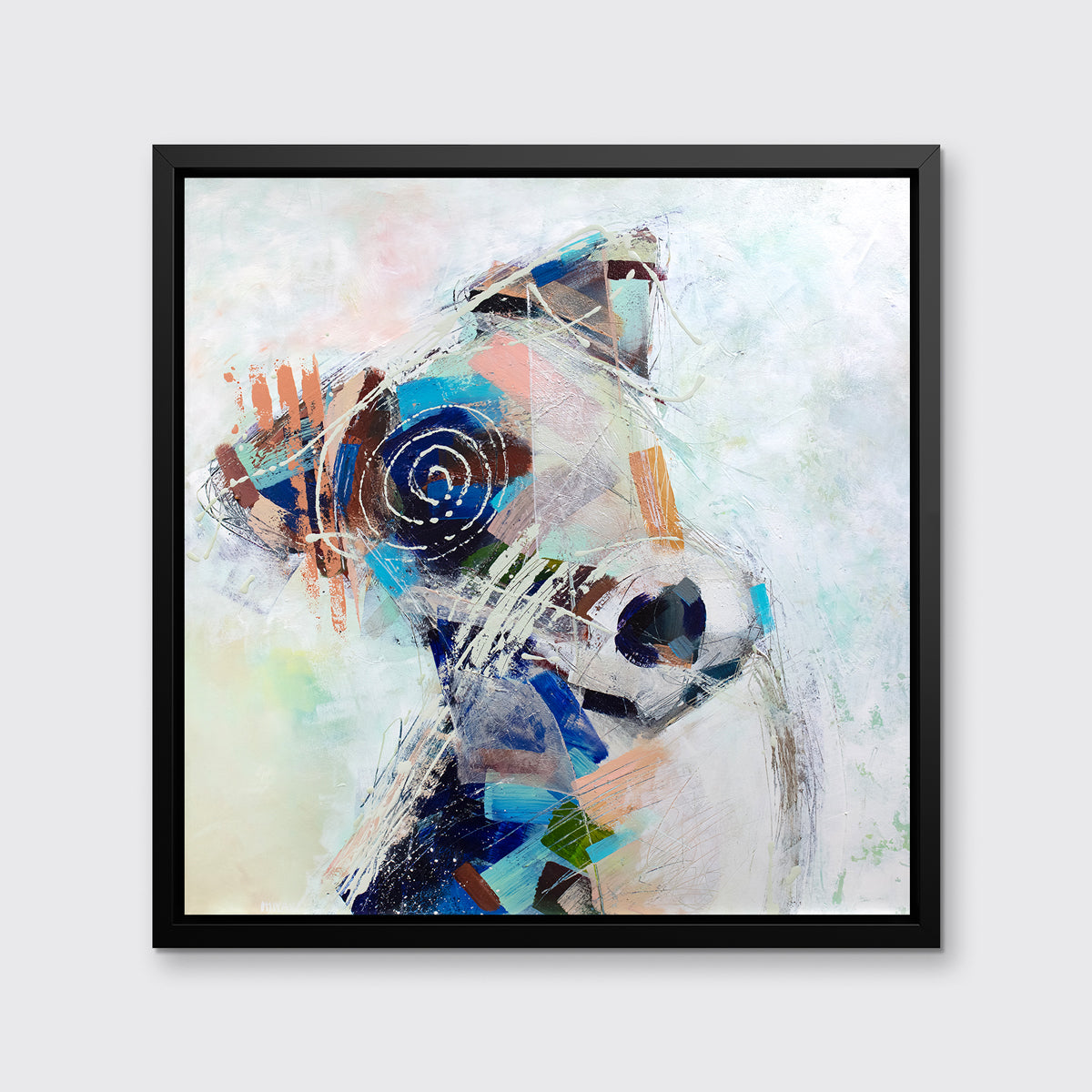 A multicolored abstract dog print in a black floater frame hangs on a white wall.