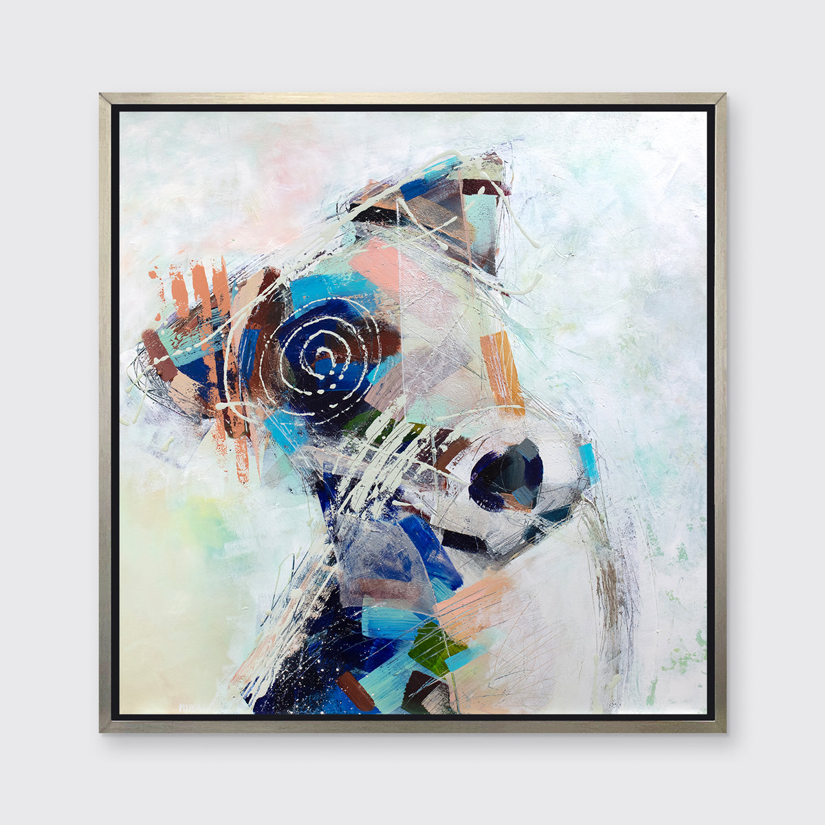 A multicolored abstract dog print in a silver floater frame hangs on a white wall.