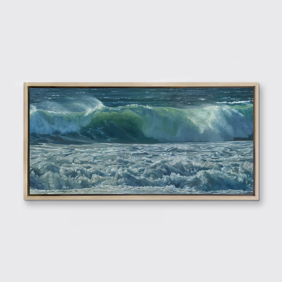 A painting of blue-green waves with white foam hangs in a white oak frame on a white wall.