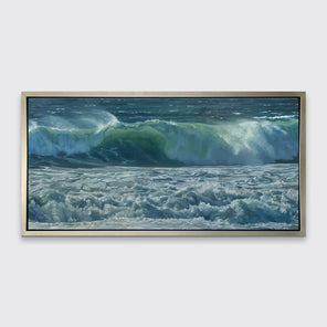 A painting of blue-green waves with white foam hangs in a silver frame on a white wall.