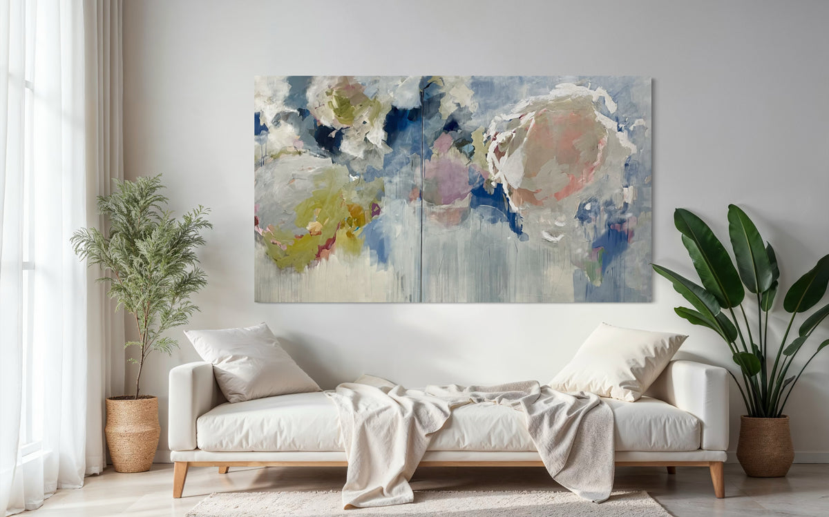 Modern living room with a white sofa, abstract floral artwork, and potted plants.
