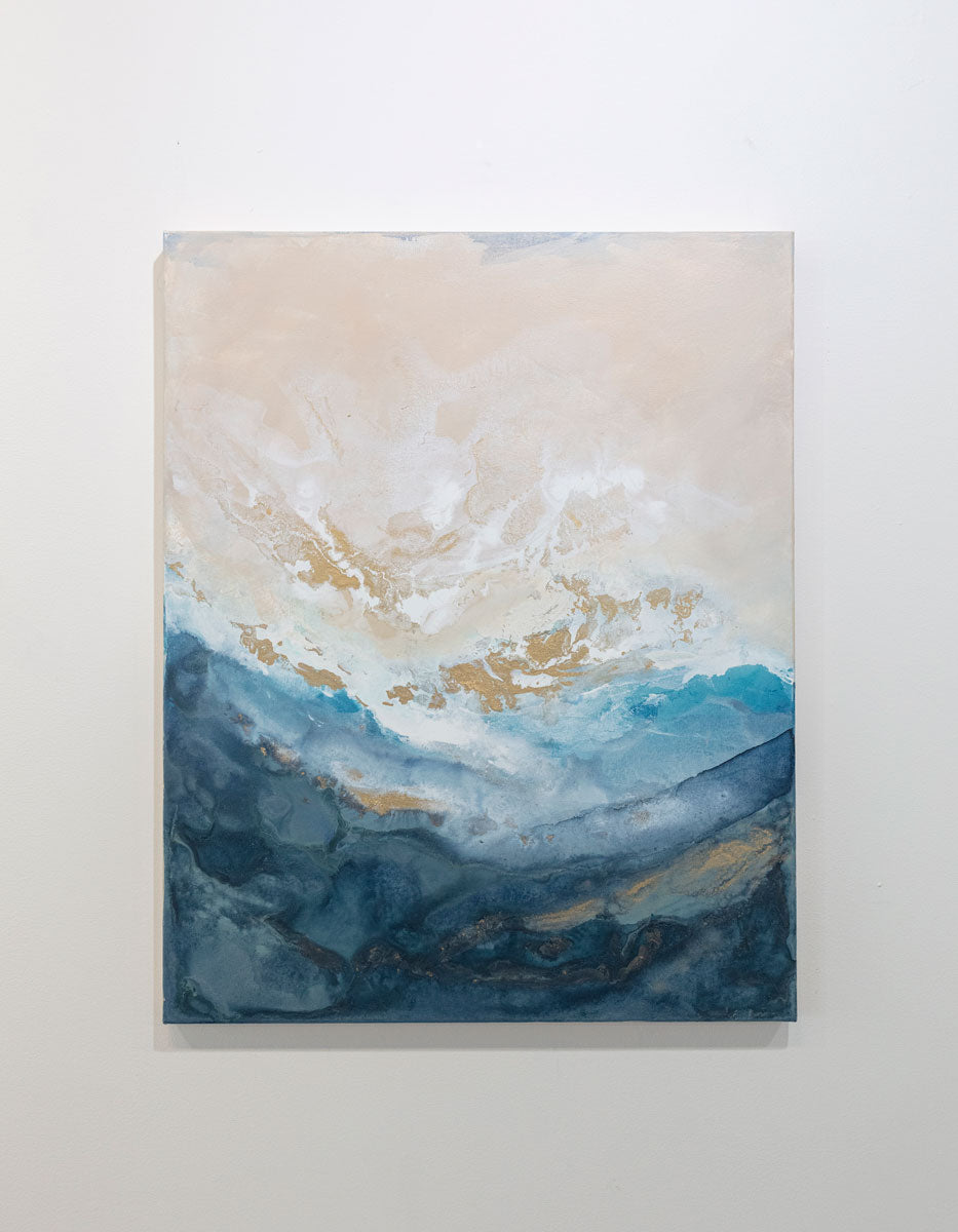 An abstract blue, gold, and white painting hangs on a white wall. 