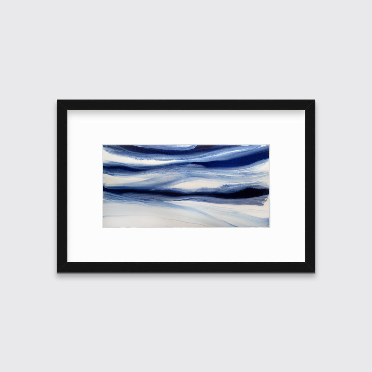 A dark blue and white abstract print in a black frame with a mat hangs on a white wall.