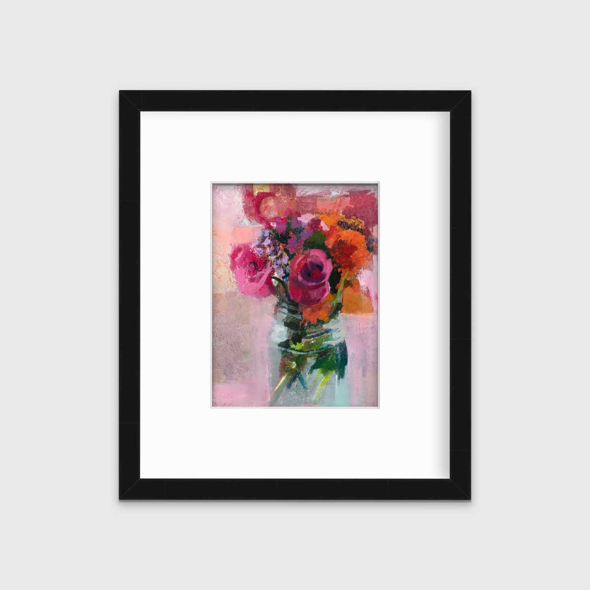 A pink, orange and green abstract floral print in a black frame with a mat hangs on a white wall.
