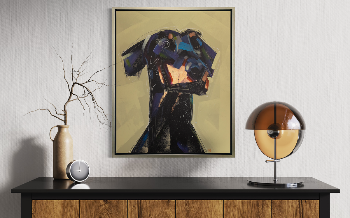 A black, dark purple, copper and chartreuse abstract dog print in a silver floater frame hangs on a white wall above a black and wood credenza with decorative accessories.
