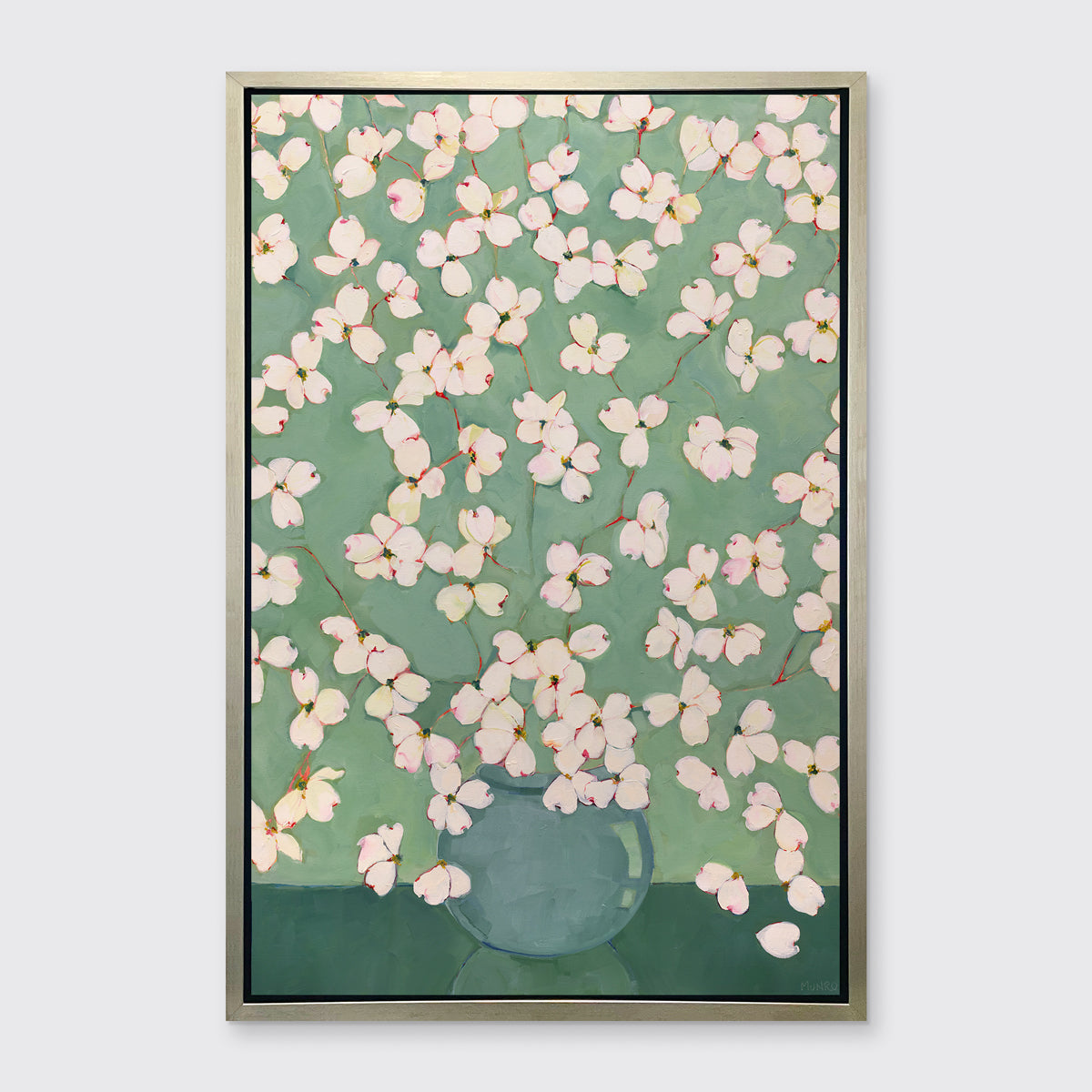 Framed artwork of dogwoods on a green background
