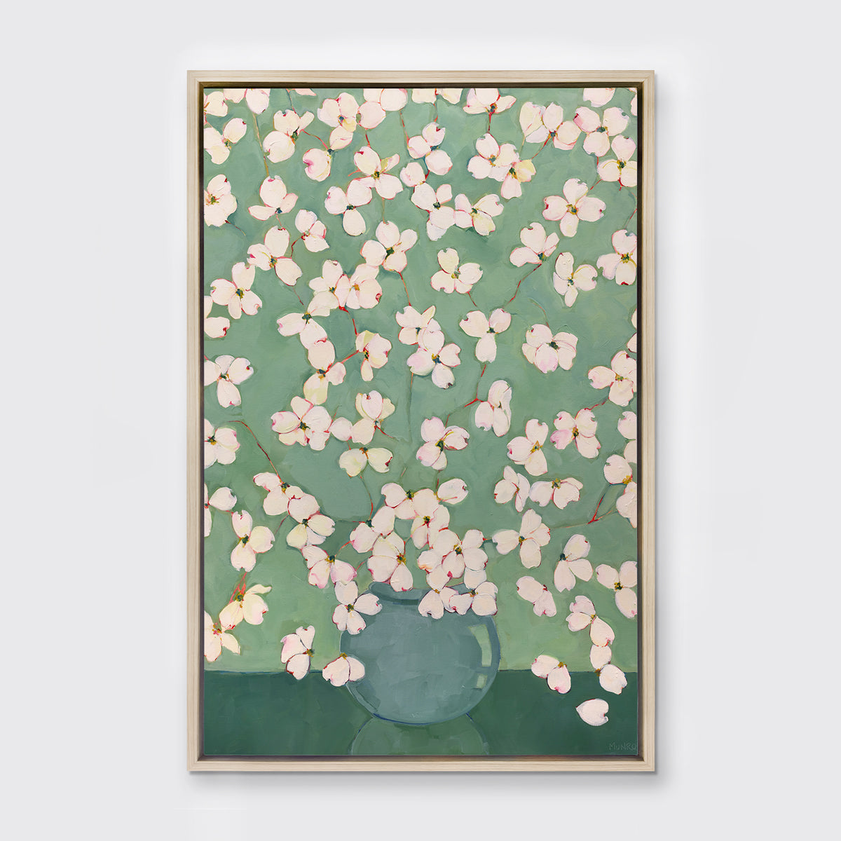 Framed artwork of a floral design with pink and white flowers on a green background