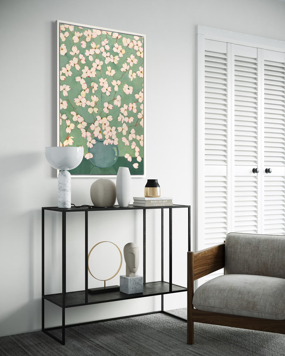 Modern living room with a console table, floral artwork, and a chair.