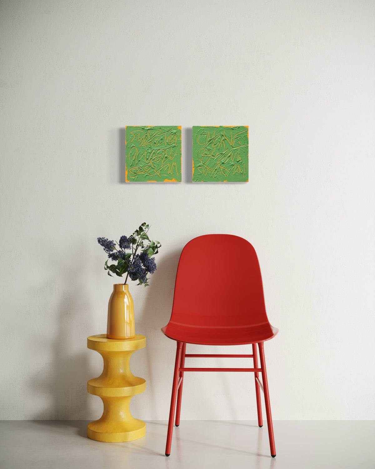 A modern red molded plastic chair with red metal legs is positioned next to a yellow tiered side table holding a yellow vase with purple flowers, against a white wall with two square abstract text based paintings with thick green paint and tangerine gestural lines, hanging above.