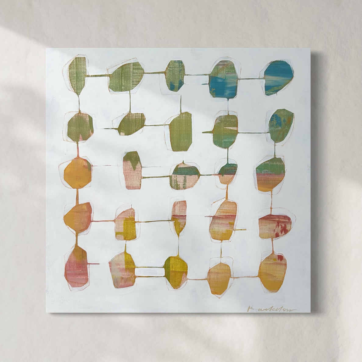 A 20" x 20" abstract painting featuring a grid of connected shapes in various colors on a white background, signed by the artist Kayla Ackelson.