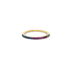 Gold ring with colorful gemstones on a white background