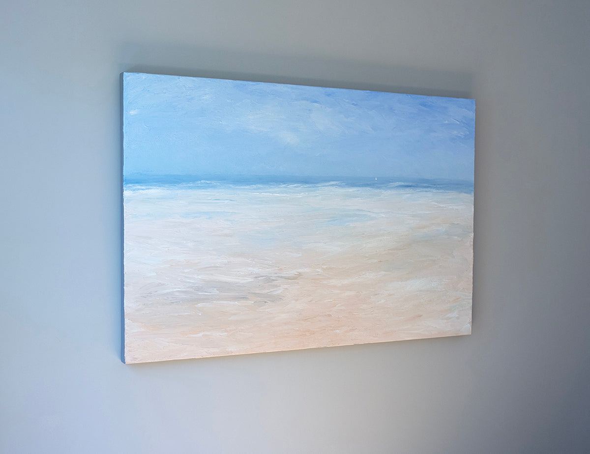 An abstracted coastal seascape painting hangs in a side view shot on a grey wall.