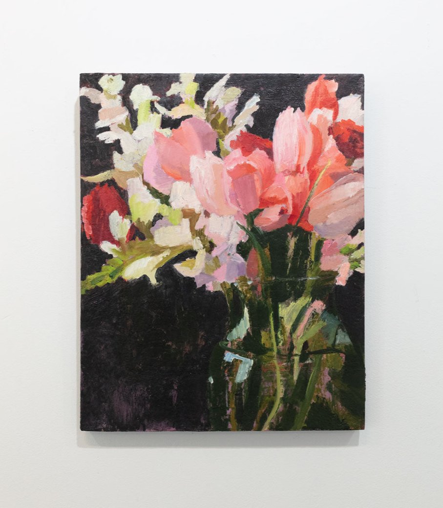 An oil painting of an abstract pink, red and white floral bouquet hangs on a white wall.
