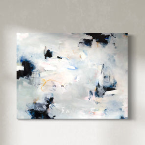 A white and black abstract painting by Kelly Rossetti hangs on a white wall.