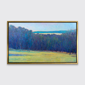 An impressionist landscape print in a gold floater frame hangs on a white wall.