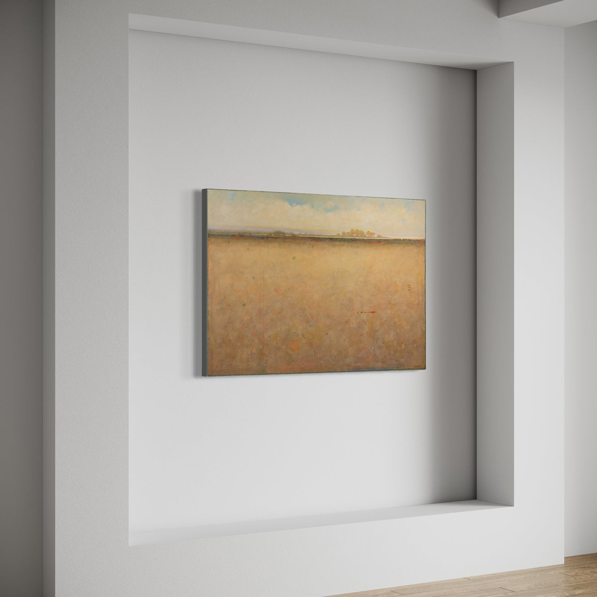 A side view of a beige and blue abstract landscape painting hangs on a white wall.