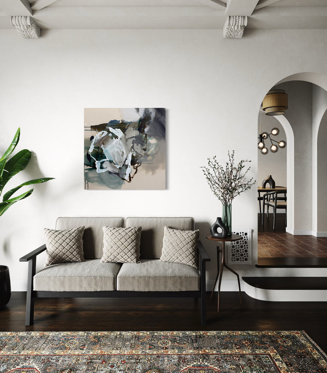 Modern living room with a gray sofa, decorative pillows, and a painting on the wall.