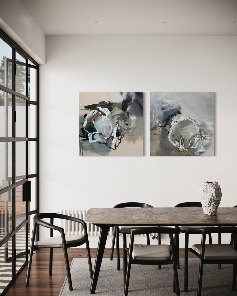 Modern dining room with abstract art on the wall and a wooden table.
